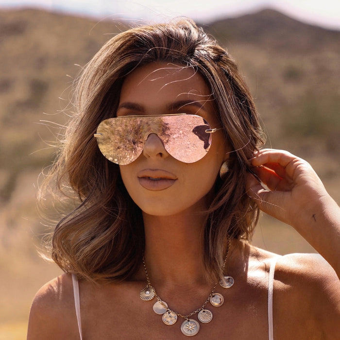 UGC - lifestyle - female wearing diff eyewear featuring the imani shield sunglasses with a gold frame and cherry blossom mirror lenses