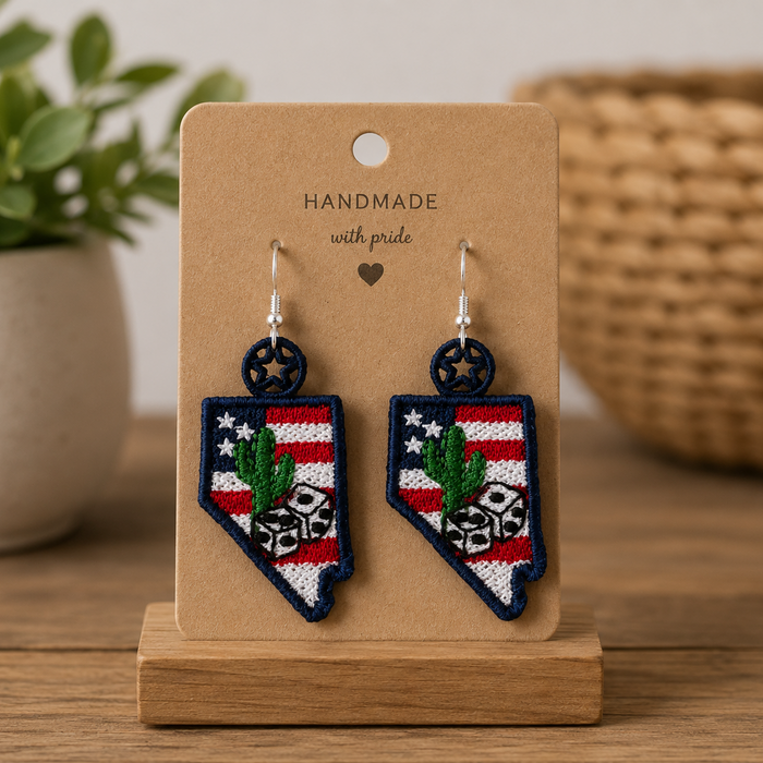 Handmade earrings on a wooden stand with a plant and woven basket in the background