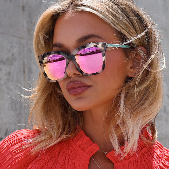 UGC - customer content - minimally_her female wearing diff eyewear bella square sunglasses with a cream tortoise acetate frame and pink mirror lenses angled view