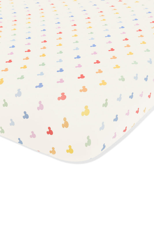 Crib sheet with pastel mickey mouse pattern on an oat background