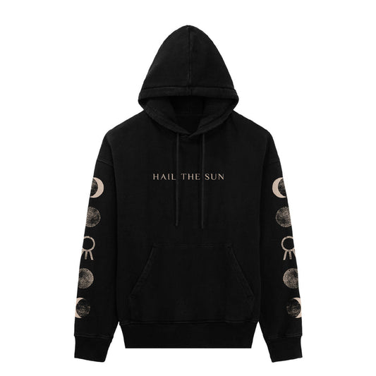 A black Hail The Sun hoodie with a front pocket and hood features "HAIL THE SUN" printed on the chest and a repeating light beige moon phase design on both sleeves. Brand: Hail The Sun.