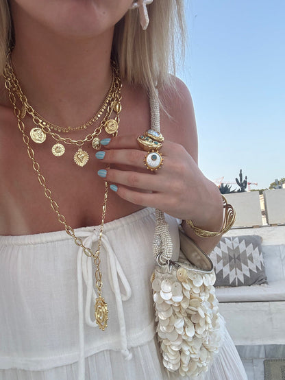 Summer jewellery stack with chunky gold necklaces