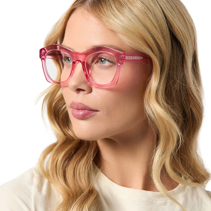 on model - female wearing diff eyewear hayden square prescription glasses with a candy pink crystal frame angled view