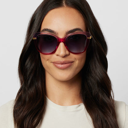 on model - female wearing harry potter x diff eyewear hermione granger 2.0 sunglasses with a ombre pink frame, gold temples and blue bell gradient lenses front view