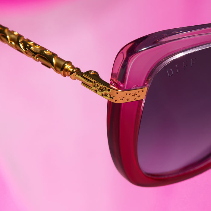 lifestyle - harry potter x diff eyewear hermione granger 2.0 sunglasses with a ombre pink frame, gold temples and blue bell gradient lenses detailed view