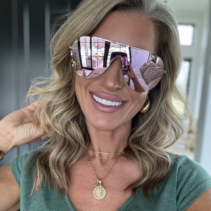 lifestyle - kalee rogers wearing diff eyewear featuring the imani shield sunglasses with a gold frame and cherry blossom mirror lenses front view