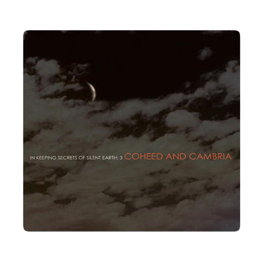 Cd cover that shows a dark night sky with clouds across the image.  There is text that reads In Keeping Secrets of Silent Earth: 3 and Coheed and Cambria as well.  There is a white border around all of this.