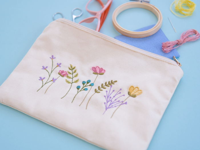 Canvas cream zipper pouch with embroidered flowers