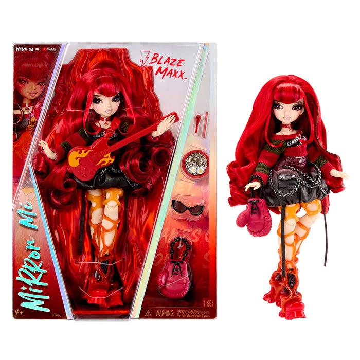 Mirror Mi Blaze Maxx doll with long red hair, shown both inside its retail packaging and standing outside it on a white background. The doll wears a black outfit with red and orange accents, holding a red guitar, and accessories are displayed on the box.