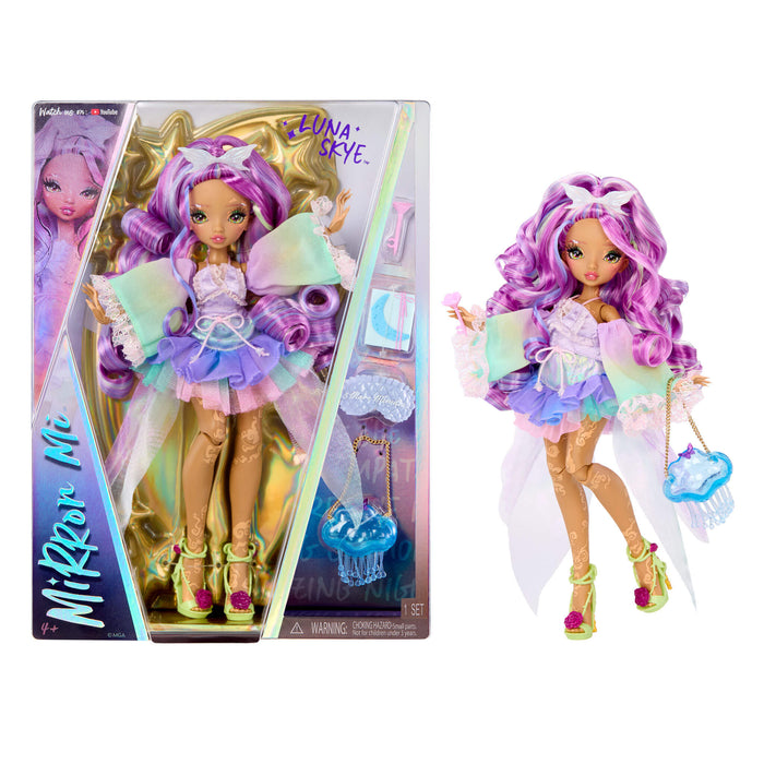 Mirror Mi Luna Skye doll shown both inside its retail packaging and standing outside it on a plain white background. The doll has long wavy purple hair, a lavender and mint tutu dress, and holds a blue purse.