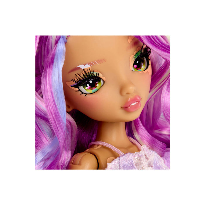 A close-up of a doll with large expressive eyes, purple and pink hair, and a light pink top, centered on a white background.