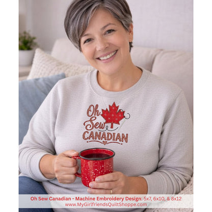Woman wearing a 'Oh Sew Canadian' sweatshirt holding a red mug.
