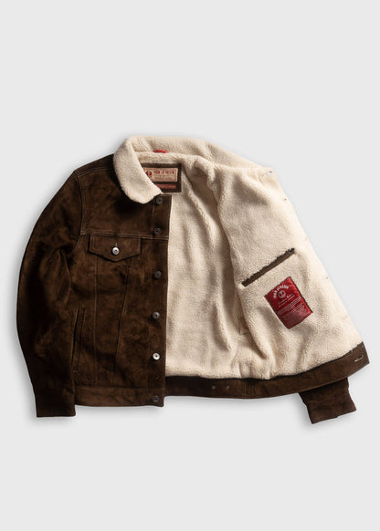 Brown suede jacket with white fleece lining, open to show interior label. Buttoned front and pocket detail visible.