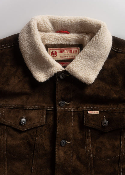 Brown suede jacket with a soft white sherpa collar, featuring Iron and Resin label, buttoned pockets, and detailed stitching.
