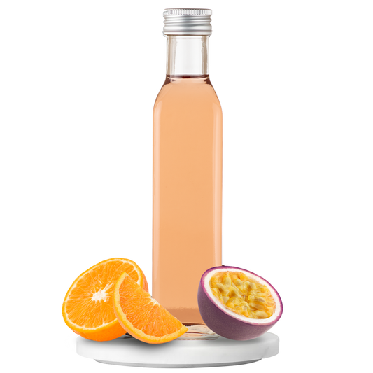 Bottle of vinegar with orange slices and a halved passion fruit