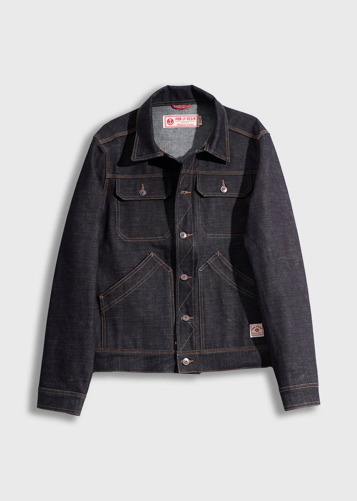 Dark denim jacket with button closure, chest pockets, and contrast stitching, displayed on a light gray background.