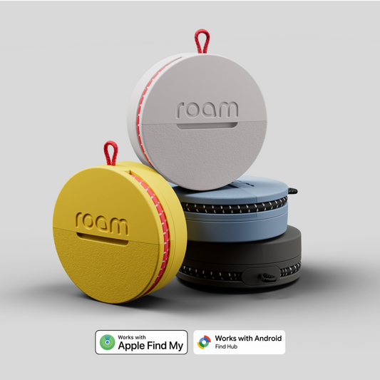 Four colorful 'roam' portable device cases stacked on a light gray background.