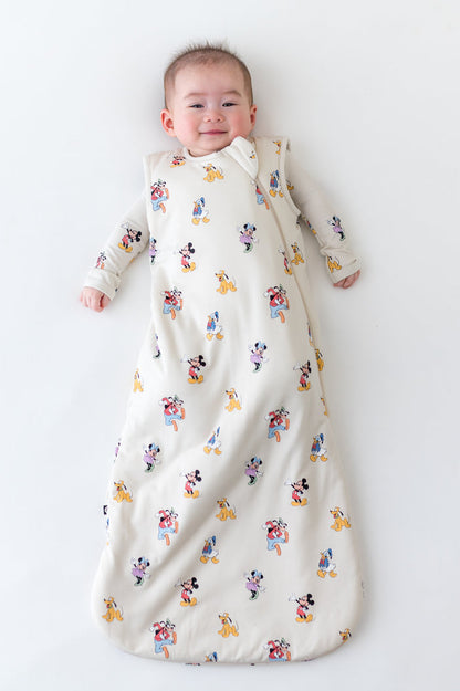 Baby in a sleep sack with mickey and friends pattern