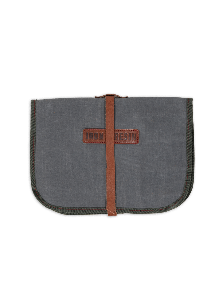 Gray canvas pouch with a brown leather strap and "Iron and Resin" logo, closed and centered on a white background.