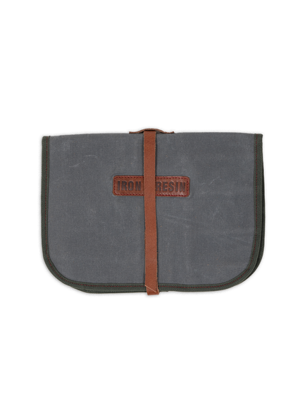 Gray canvas pouch with a brown leather strap and "Iron and Resin" logo, closed and centered on a white background.