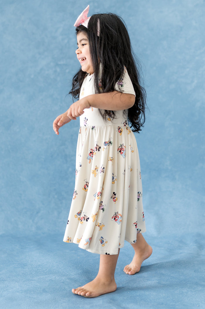 Girl wearing dress with mickey and friend pattern