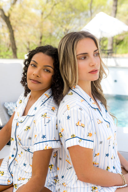 2 Models wearing Kyte Women's short sleeve pajama set in Amalfi Coast print sitting together