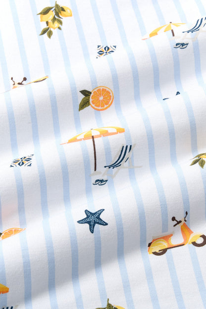 Close up of the Bamboo fabric: A repeating, all-over print featuring: a bunch of three lemons with stems, leaves, and a white blossom; an orange-and-yellow Vespa; an orange slice circle; a white sailboat with three white seagulls in the distance; a white Italian ceramic tile painted with a navy, orange, and pale yellow design; a sling beach chair with white and navy stripes next to an orange-and-white striped beach umbrella, over a background pattern of white and light blue stripes.